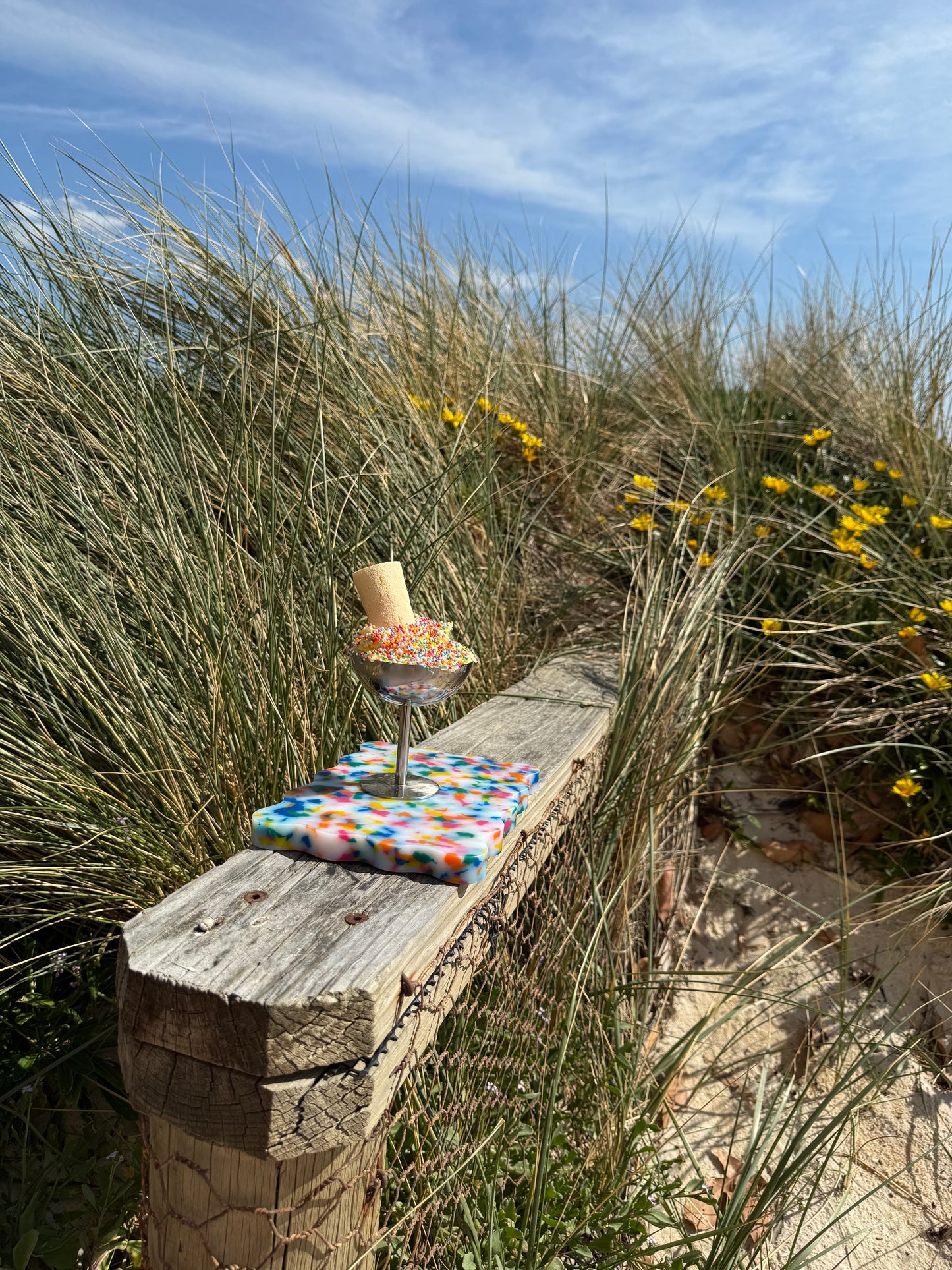 Colourful chopping board sitting on wooden ledge with 100s and 1000s
