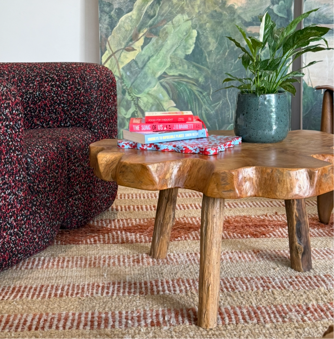 Pastel blue and red wavy chopping board styled on a wooden coffee table.