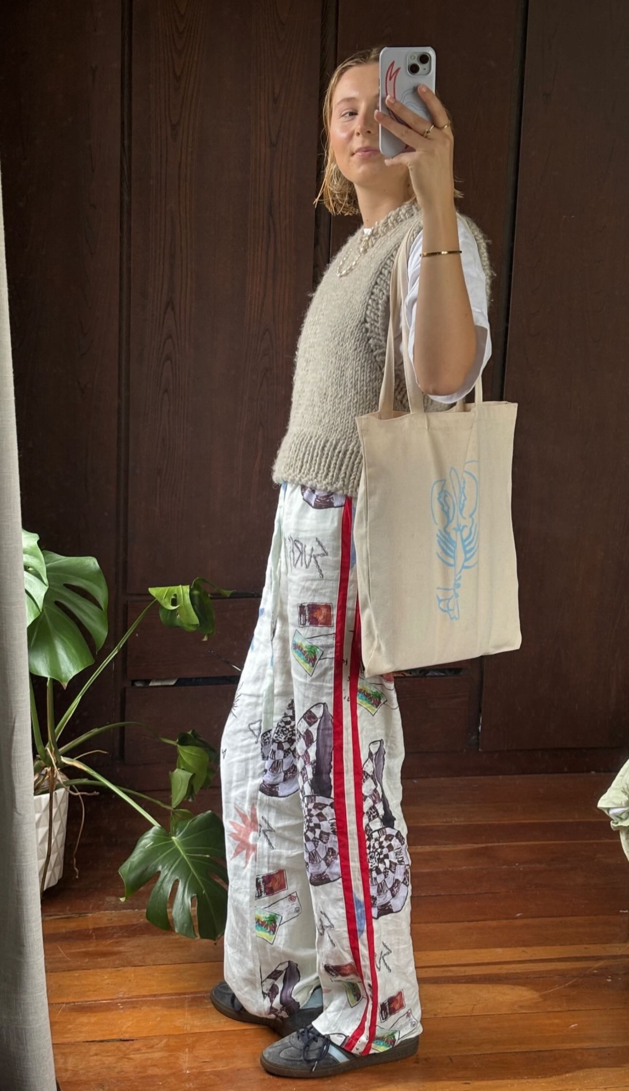 A beige cotton canvas tote bag used as a library bag.