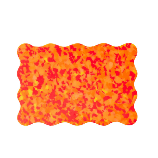 Orange and red wavy Pinchy chopping board – terrazzo-style kitchen board on white background