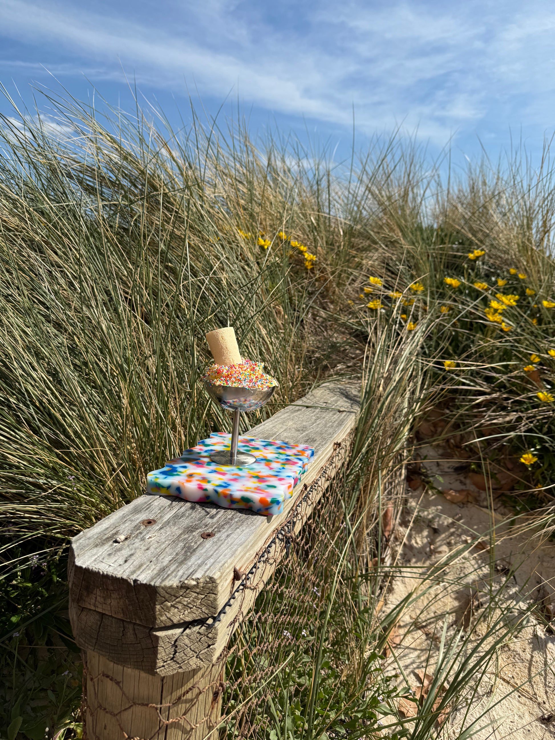 Colourful chopping board sitting on wooden ledge with 100s and 1000s 