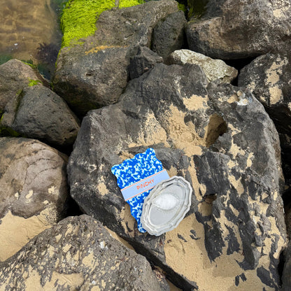 Navy and white designed chopping board with silver platter on top. 